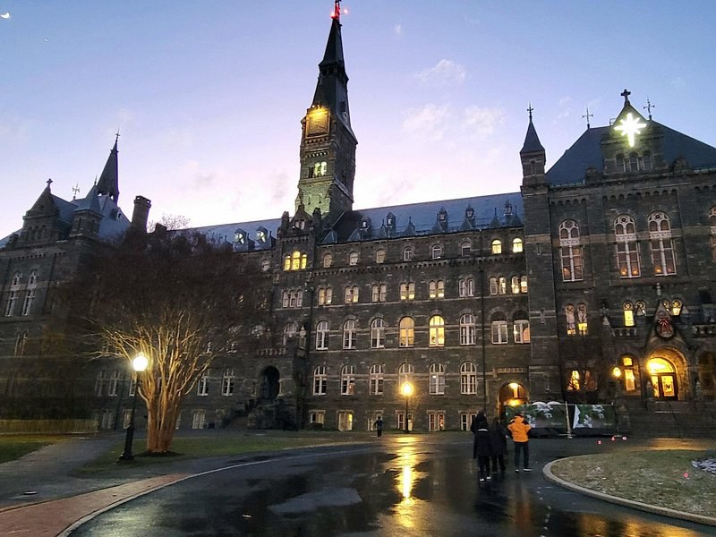 Georgetown's university towers and lamps at dusk