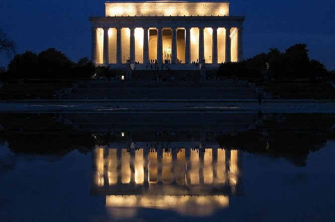 The columned memorial at the west end of the Mall, lit up and mirrored in the Reflecting Pool