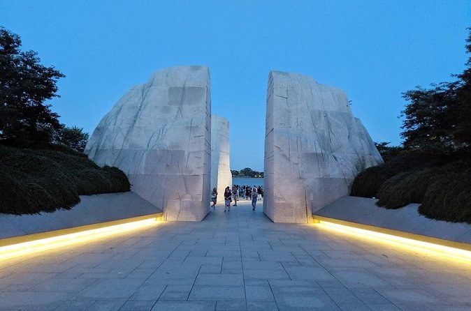 The Martin Luther King, Jr. Memorial's Stone of Hope at dusk, lit from the path