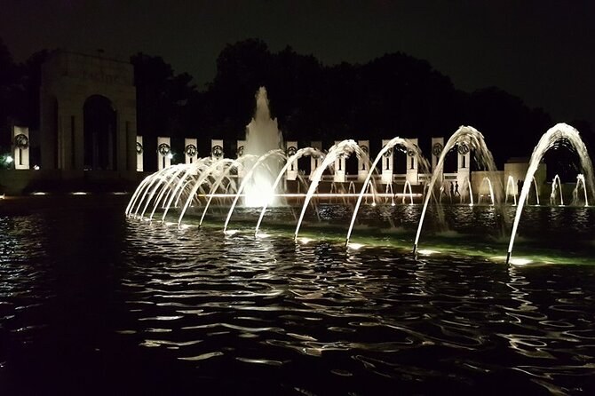 The World War II Memorial's fountains and pillars lit up after dark